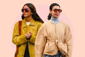 two women, one wearing a yellow jacket and red purse and the other wearing a tan jacket