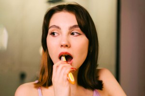 brunette woman brushing teeth