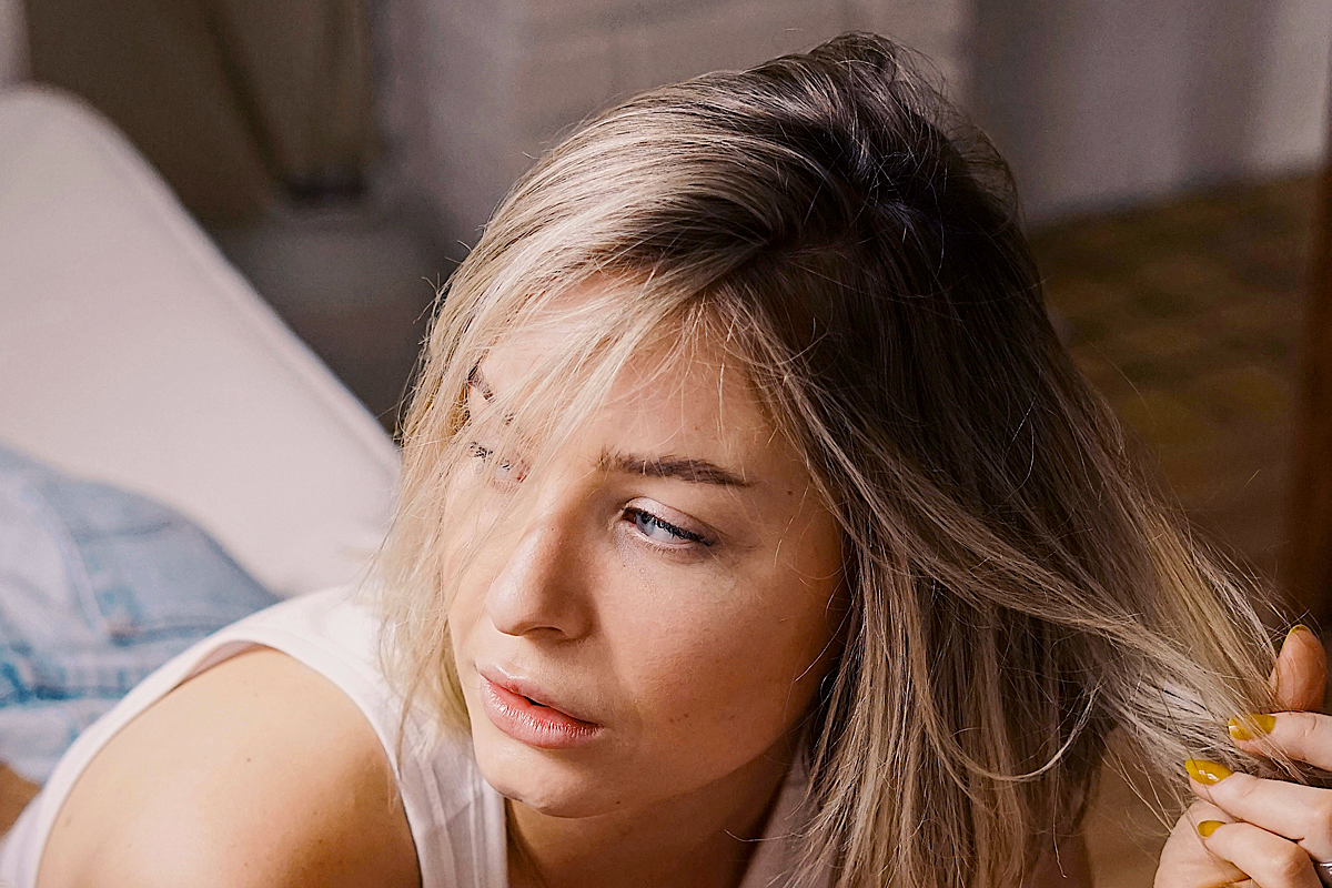 woman with blonde hair with dark roots