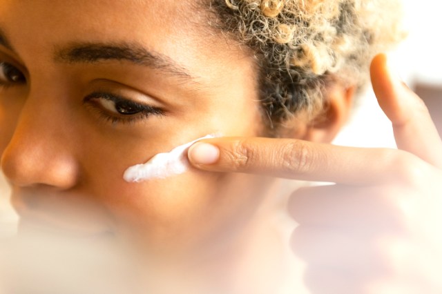 woman with a swipe of sunscreen on her cheek