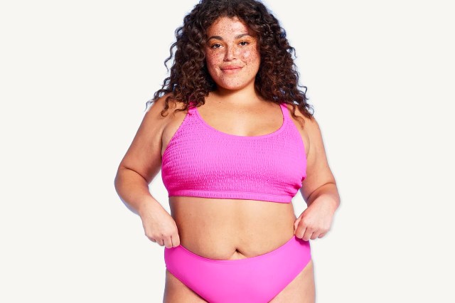 Woman with freckles and brown hair wearing a pink bikini