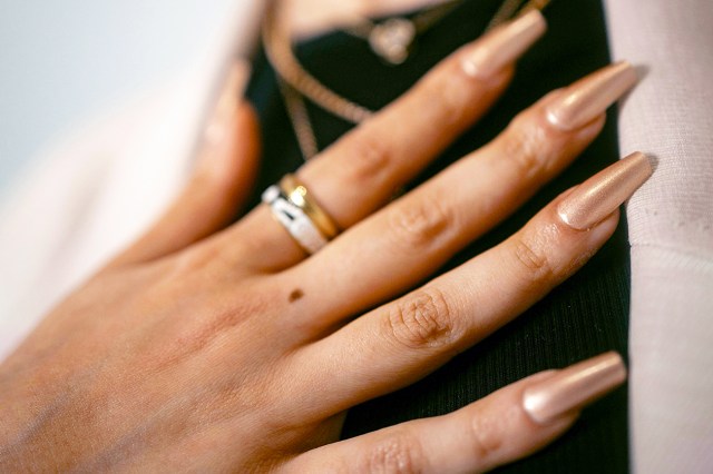 a woman's hands with two rings on her fingers