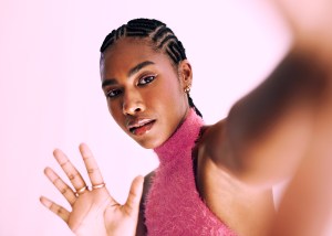 Black woman with pink eyeliner and pink shirt