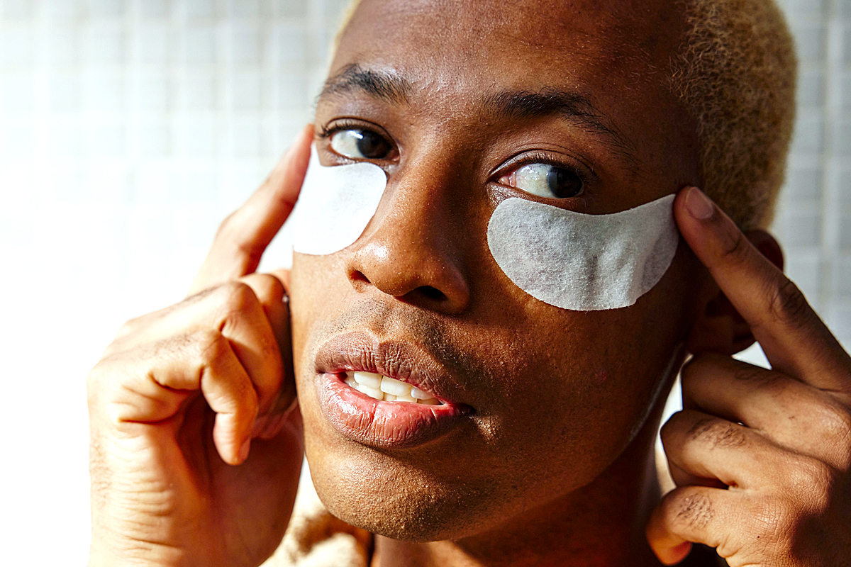 man with eye patches on his face