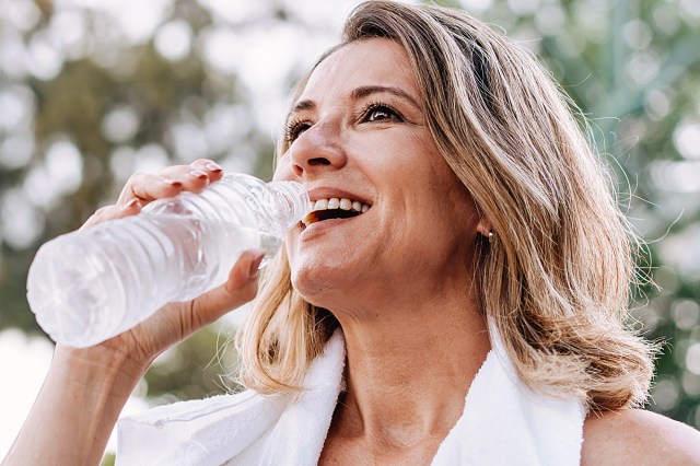 blonde older woman drinking water