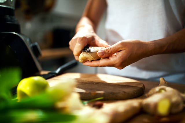 woman peeling vegetables for a smoothie