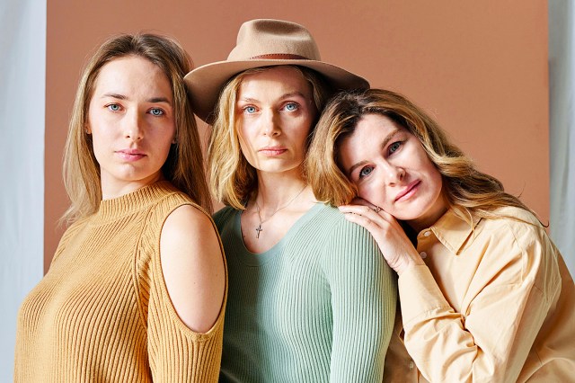 a group of three women standing next to each other