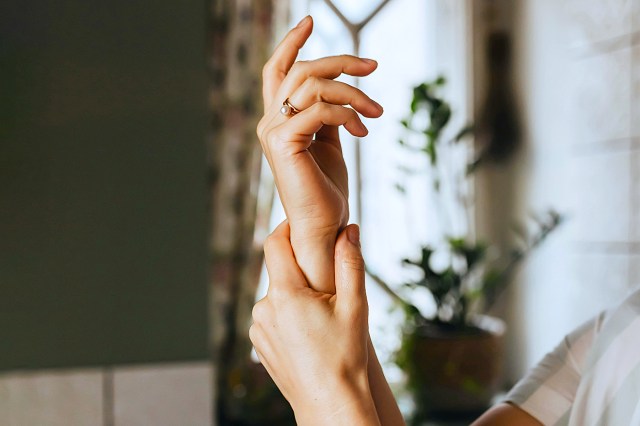 a woman holding her hands up in the air