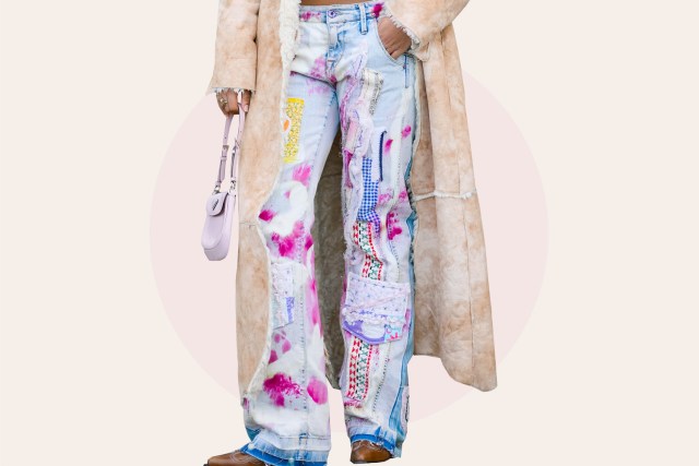 A guest wears , a white turtleneck , a blue shirt, a beige long fluffy coat, colored denim jeans pants , a pink Prada bag