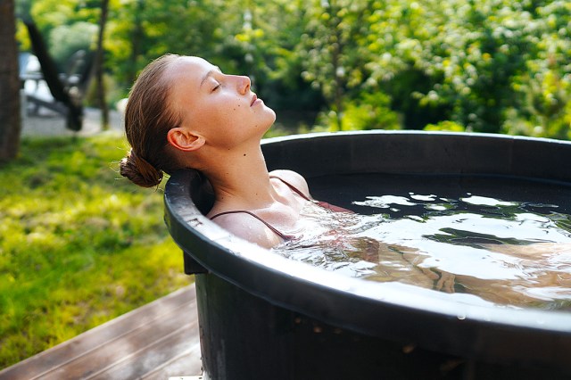 Young woman taking an ice bath