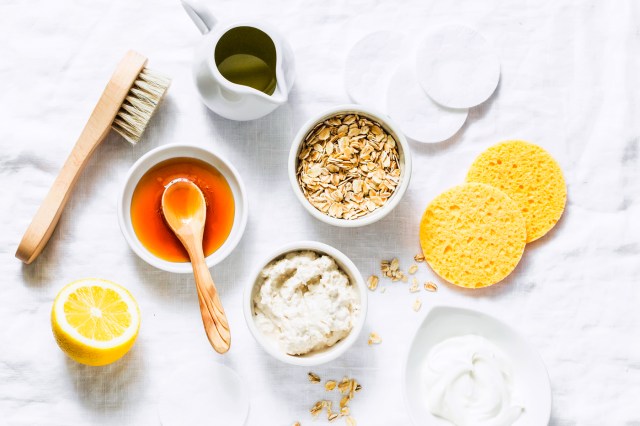 Flat lay/still life of beauty products such as honey, oats, sponges, brush, etc