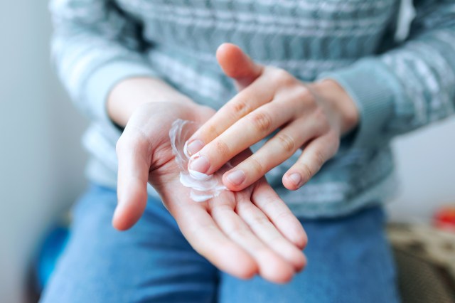 Close-up of person with white cream in their hands