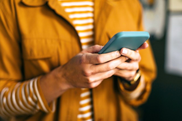 Close-up of woman holding phone in hands