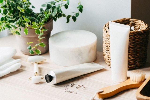 Beauty/skin care products on counter, with plant