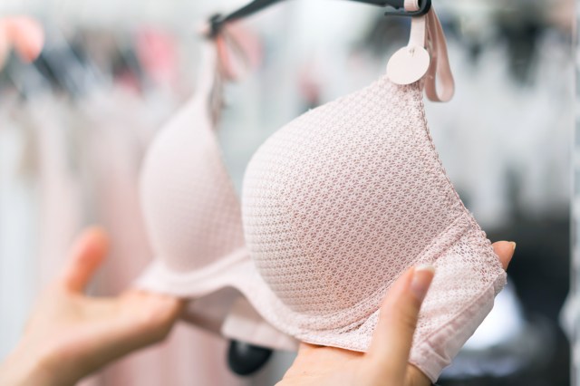 Woman holding bra, shopping