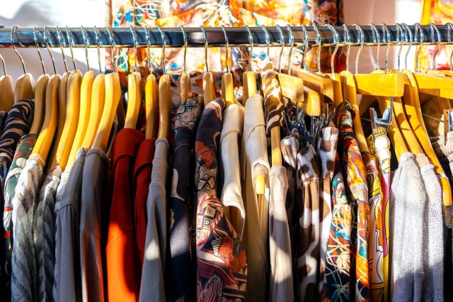 Colorful rack of clothes on hangers in a store