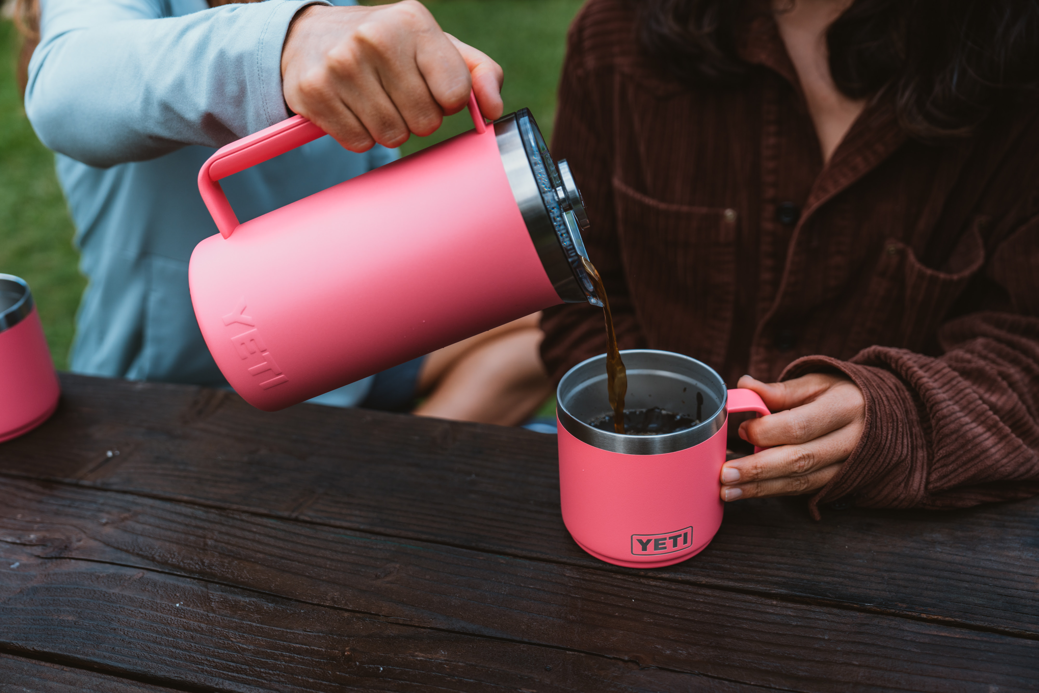2 people outside pouring coffee with the YETI rambler french press