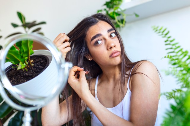 Portrait of girl running fingers through her hair