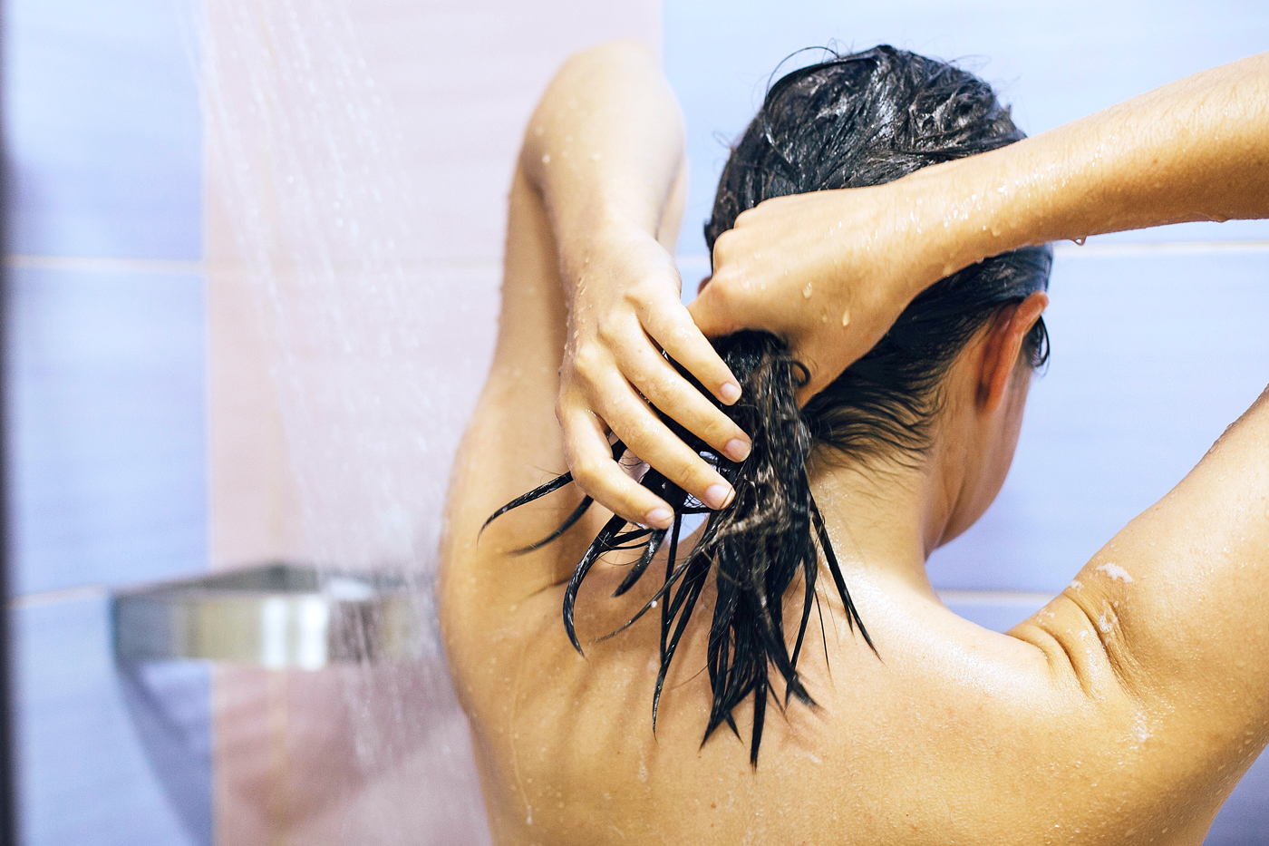 woman washing her hair in the shower