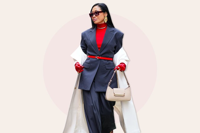 Miki Cheung wears sunglasses, golden earrings, a red turtleneck pullover, a gray oversized blazer jacket , red leather gloves, a white long coat