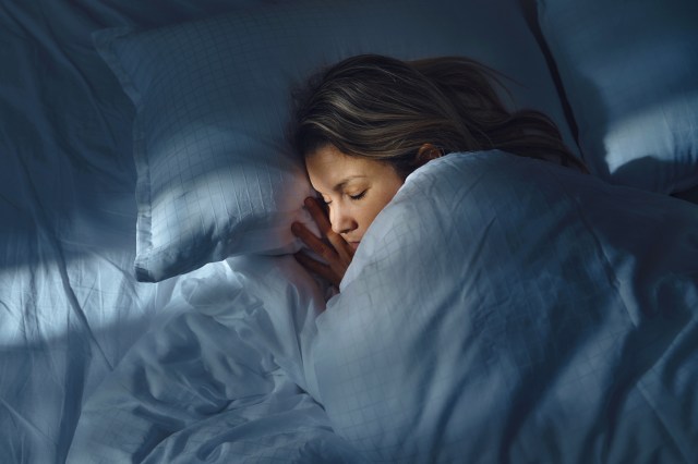 Woman sleeping in bed at night