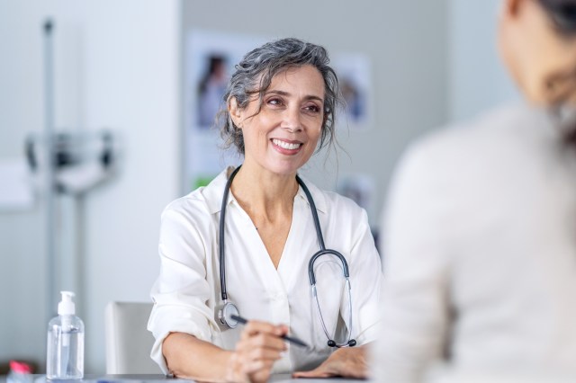 Female doctor talking to patient in office