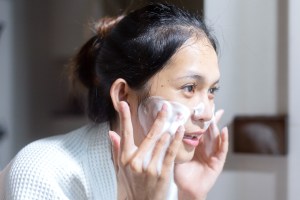 woman washing face in the shower