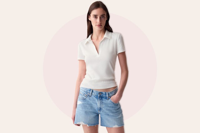 Woman wearing white collared t-shirt and jean shorts