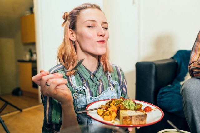 Woman eating a home made vegan dish