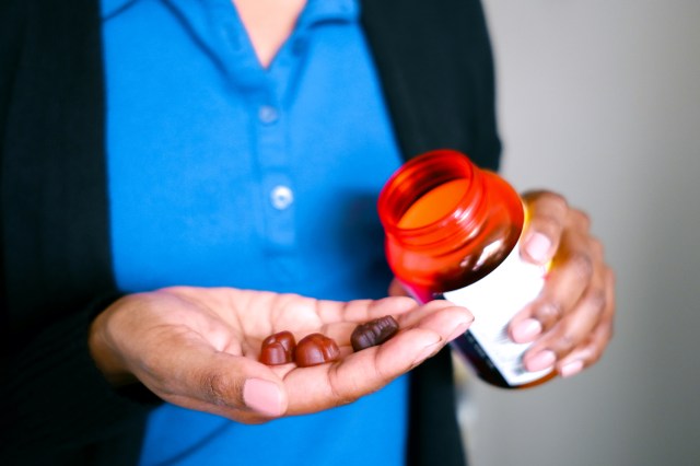 Woman Holds Fruit-Flavored Multivitamins