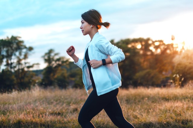 Woman jogging on country road