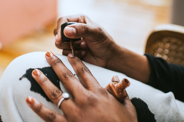 Woman painting her nails at home