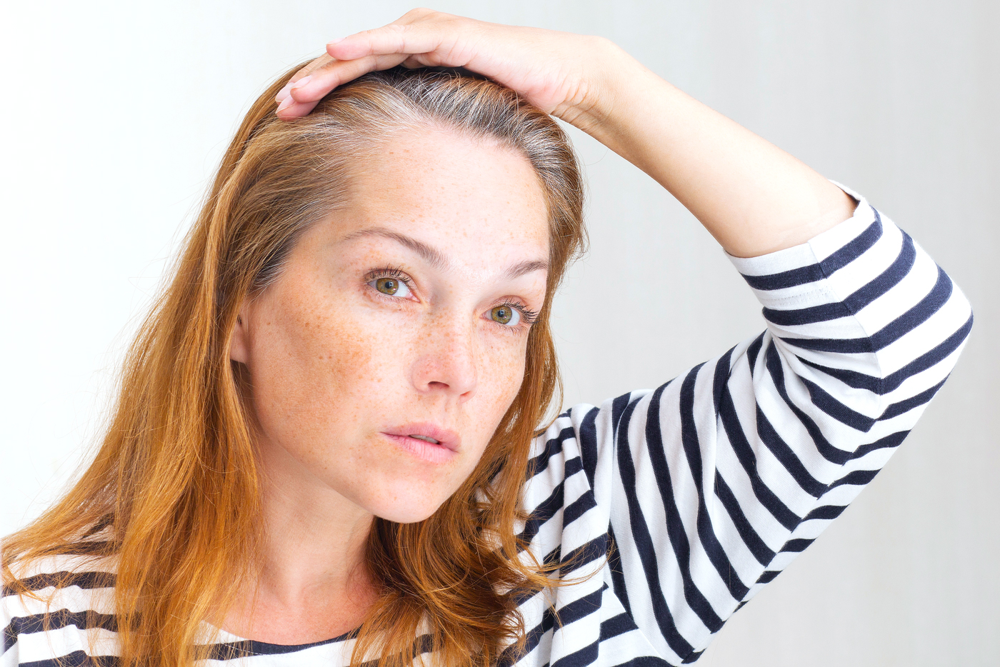 redheaded woman with gray roots