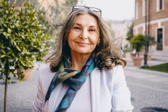 Portrait of mature, smiling woman outside