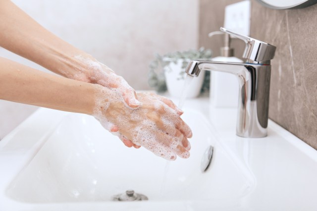 Washing hands under the faucet