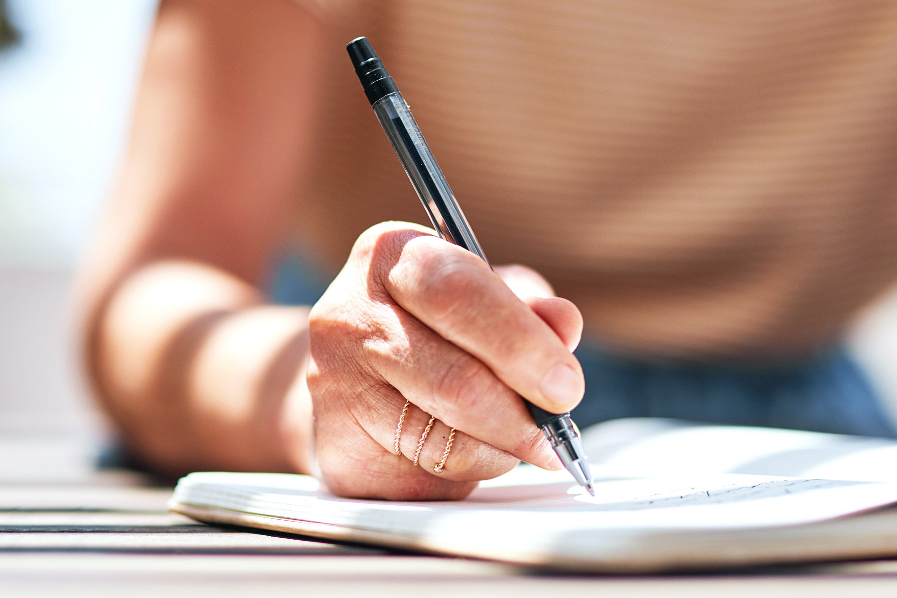 Close up of hand writing in a journal