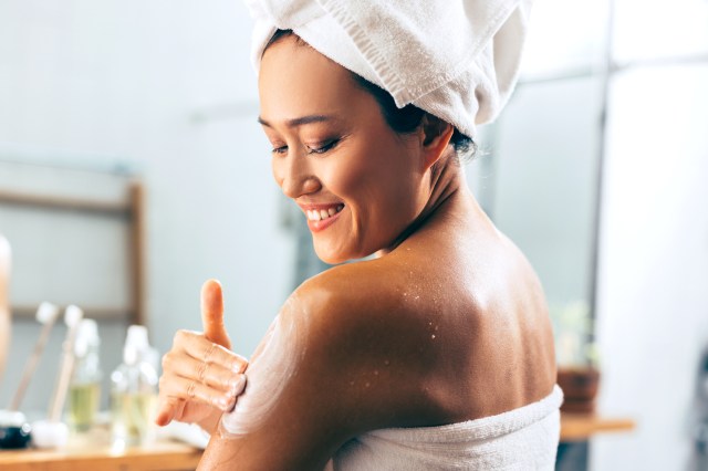 Woman Putting On Cream After A Shower