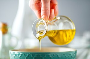 Person pouring olive oil