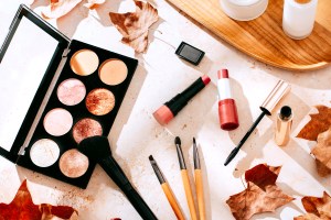 Autumn makeup concept with beauty products on table