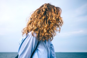 Side view of woman with wavy hair