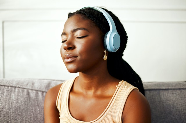 Woman with her eyes closed listening to music with headphones