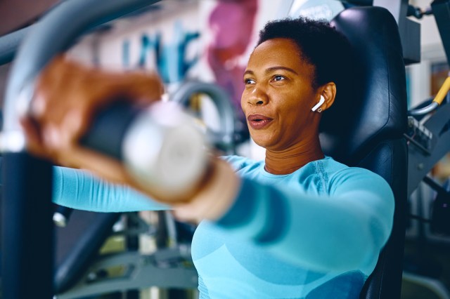 Woman working out on machine at gym