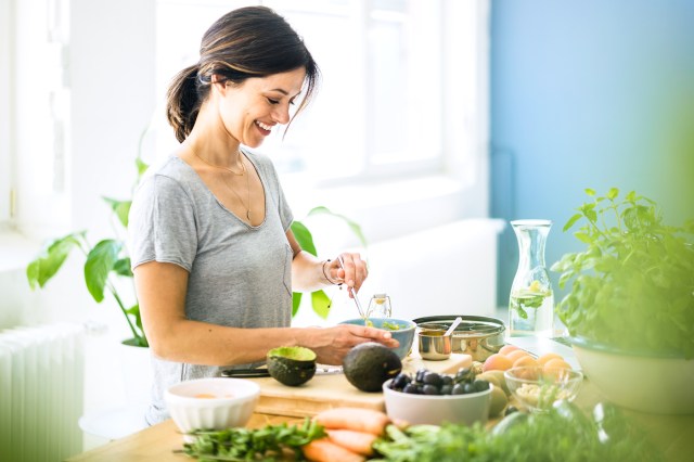 Woman preparing healthy food in her kitchen