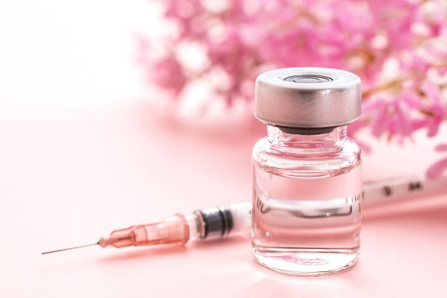 Syringe, cosmetic injection, pink background