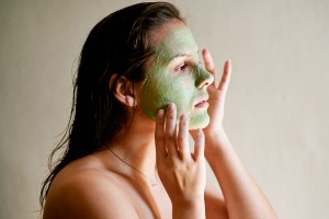 Woman using beauty face mask