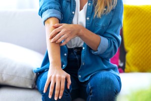 woman scratching her arm