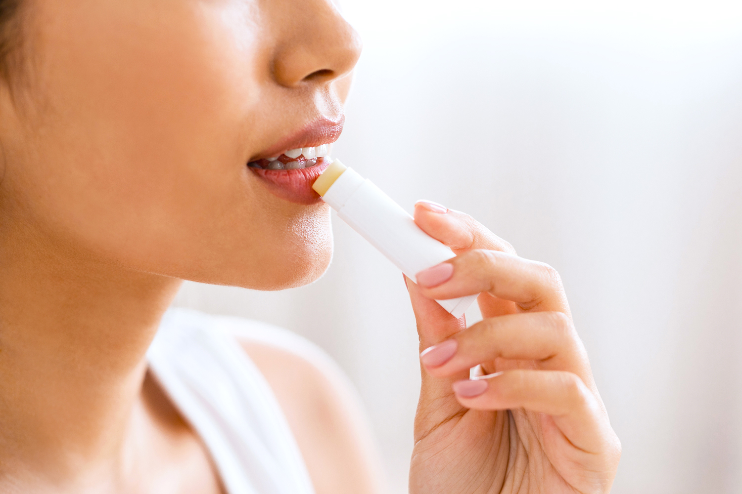 woman applying lip balm