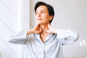 woman touching neck